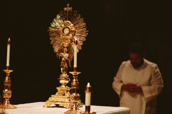 priest-praying-in-eucharistic-adoration